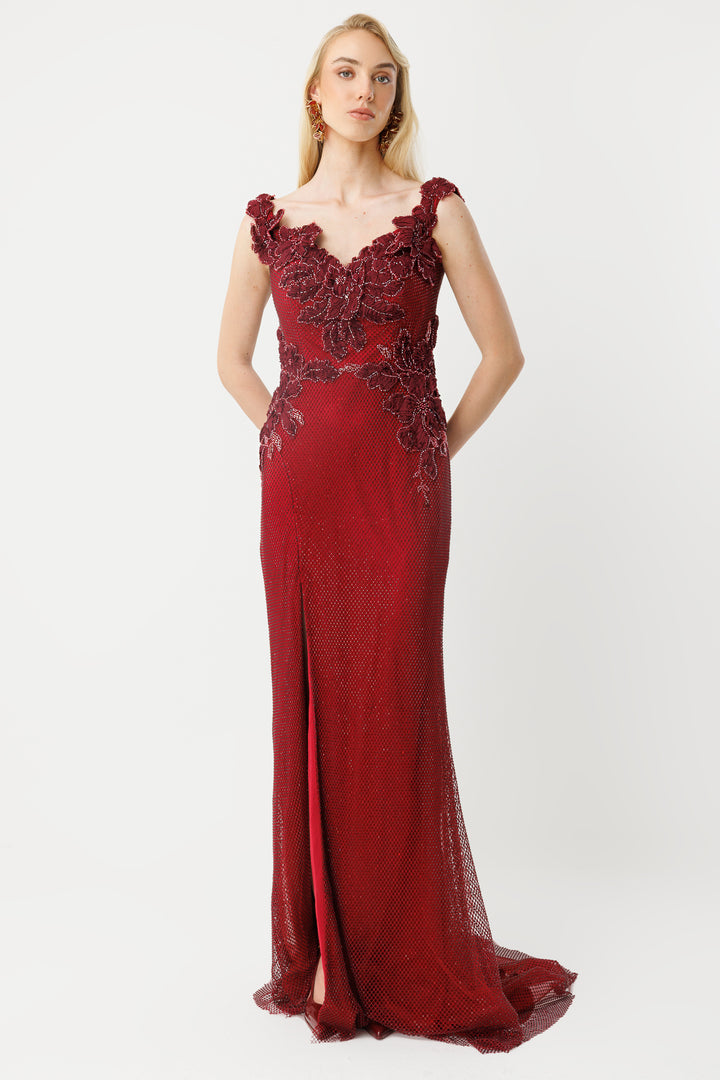 Off-the-shoulder long evening dress with appliqué and slit.